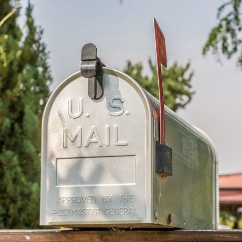 US mailbox from the front with upright flag